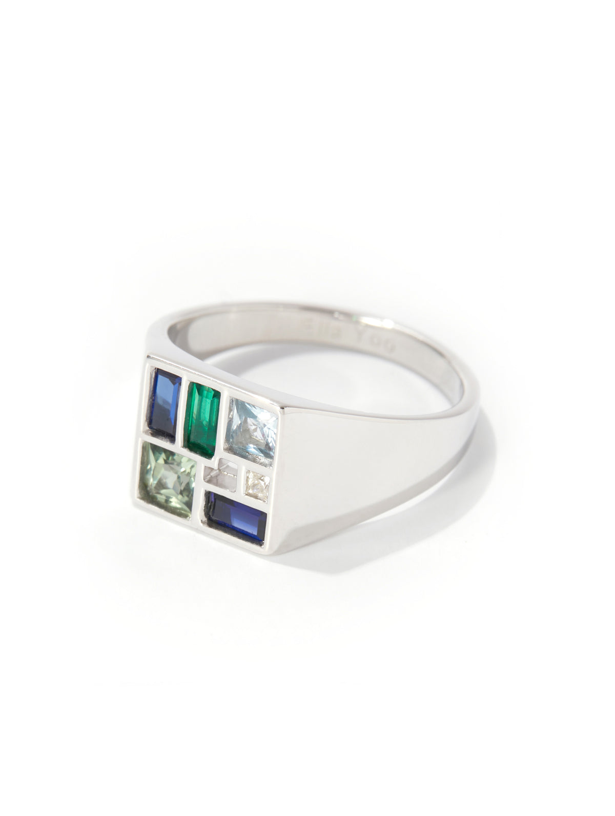 Silver ring with colorful gemstones on a white background