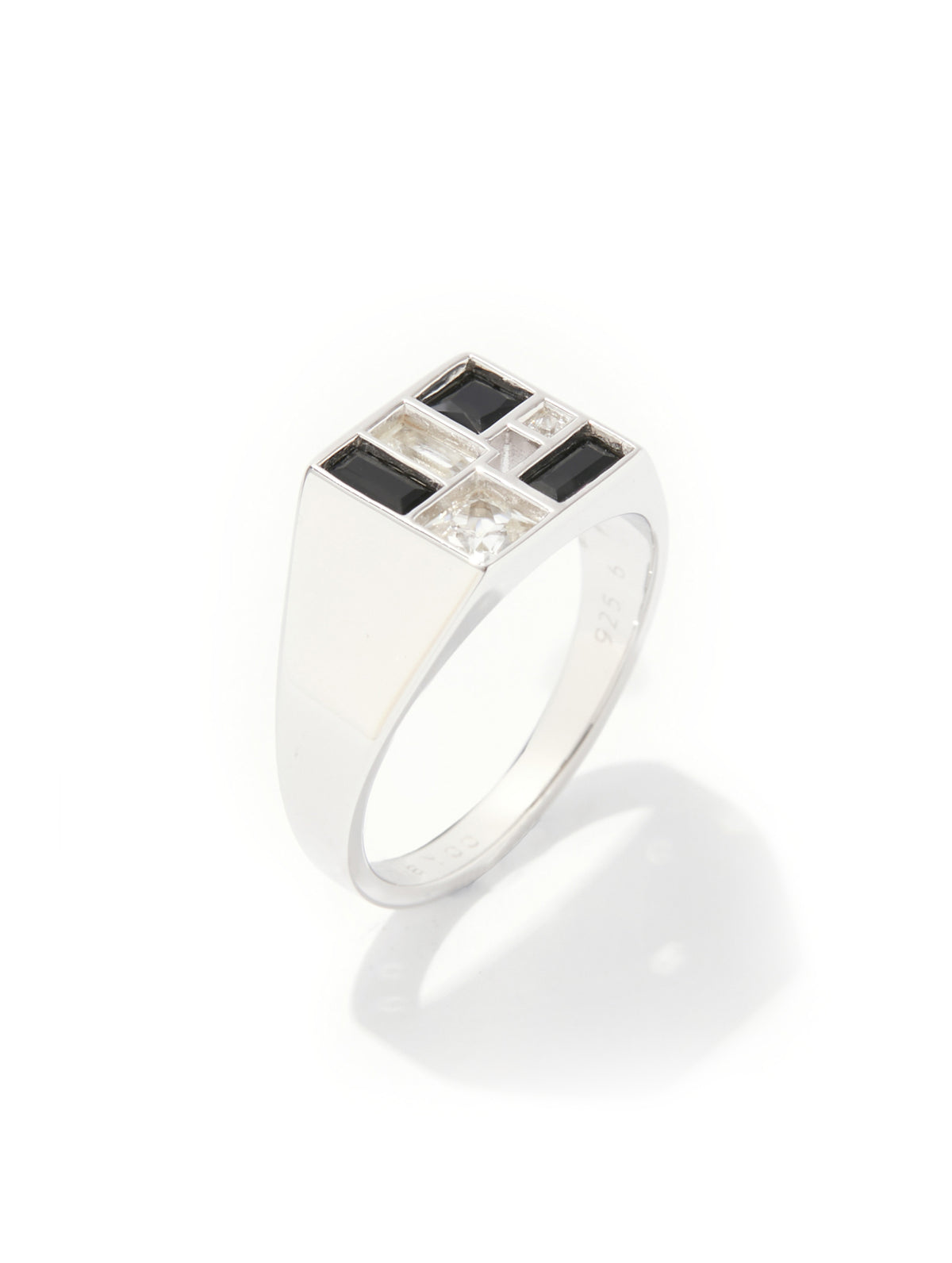 A silver signet ring featuring a square face with alternating black and clear rectangular stones, set against a clean white background with a soft shadow.