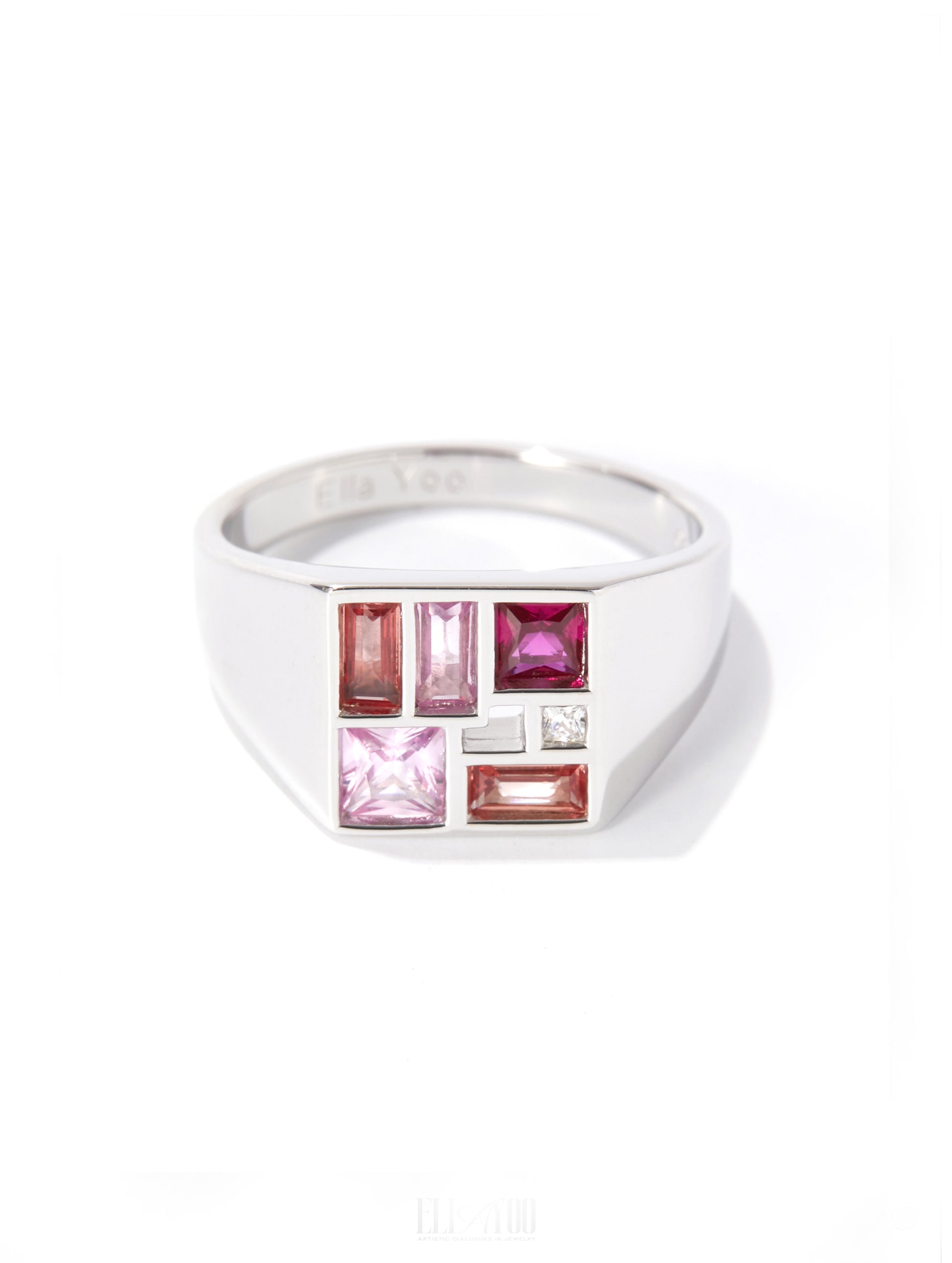 A silver-toned men's signet ring featuring a geometric face with pink, red, and clear gemstones, shown on a white background.