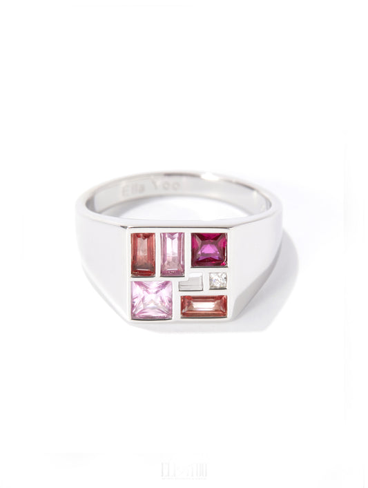 A silver-toned men's signet ring featuring a geometric face with pink, red, and clear gemstones, shown on a white background.