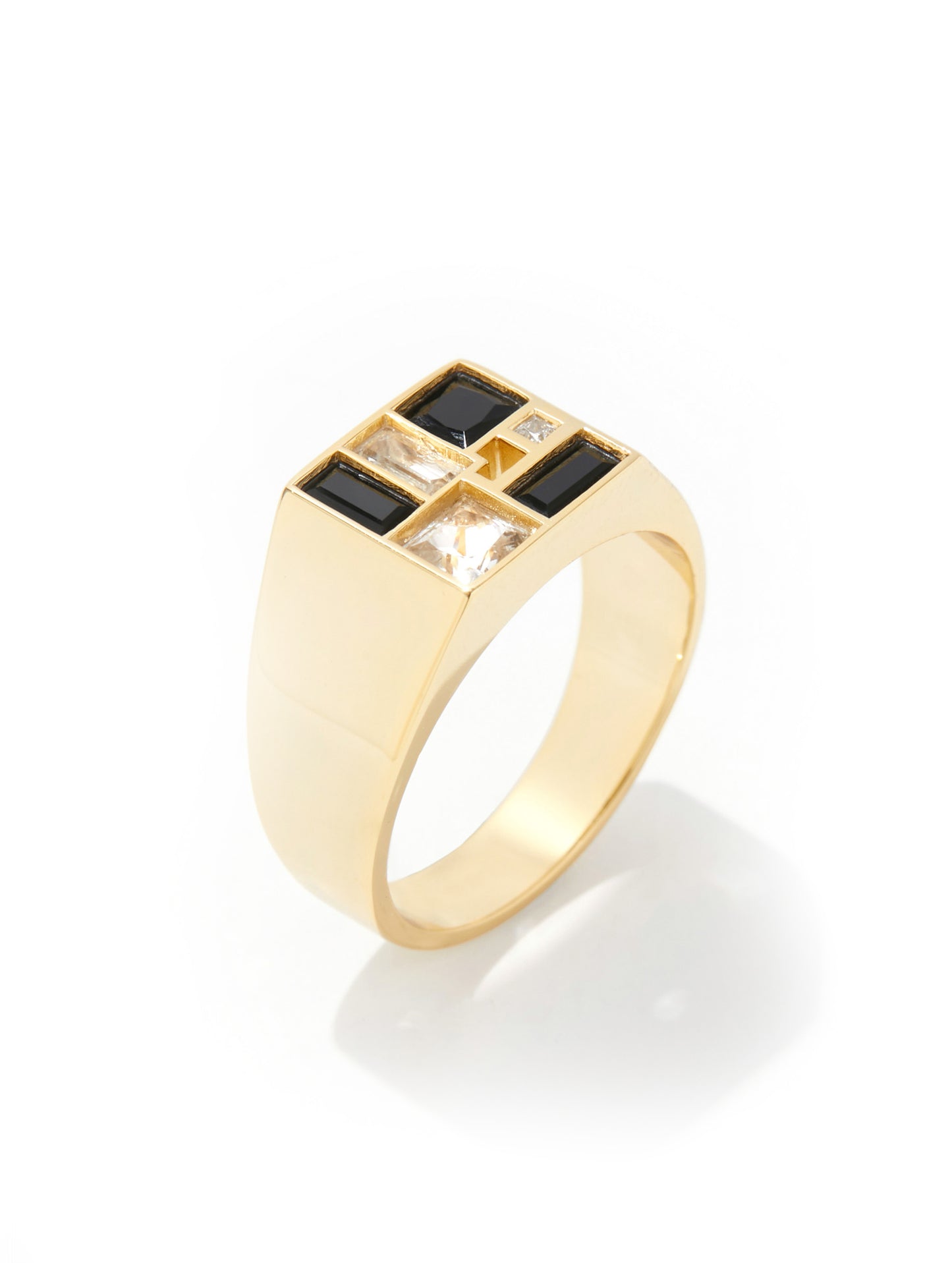 A gold signet-style ring with a square top featuring alternating black and clear baguette-cut stones, photographed on a clean white background.
