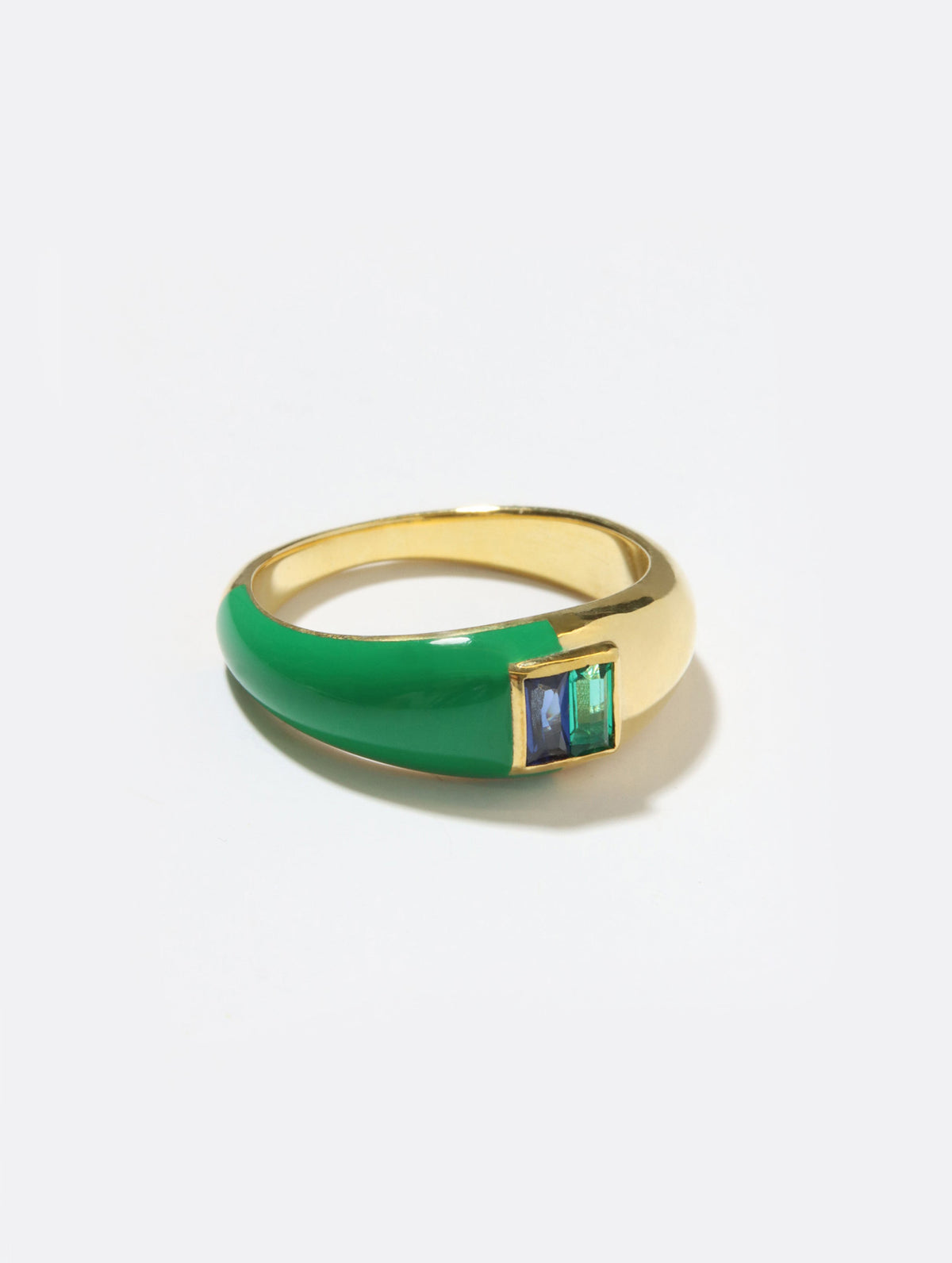 A gold ring with a thick green enamel band and a square bezel-set green stone, photographed on a clean white background.